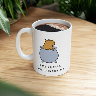 Capy Life white ceramic coffee mug featuring a cute capybara in a pot with the text In my defense I was unsupervised