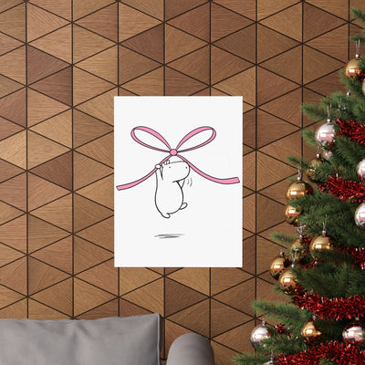 Capy Life nursery wall art featuring a minimalist capybara illustration hanging from a pink bow on a wooden wall.
