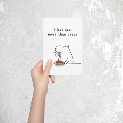 Capy Life printable greeting card featuring a minimalist capybara eating spaghetti with the text I love you more than pasta