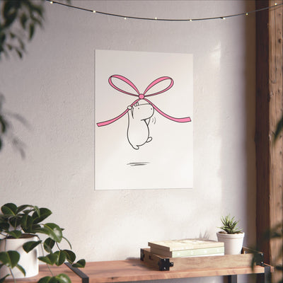 Capy Life minimalist wall art print featuring a cute capybara hanging from a pink bow on a neutral nursery wall.
