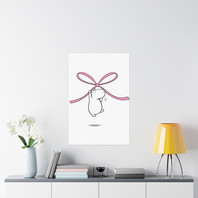 Capy Life nursery wall art featuring a minimalist capybara illustration floating while holding a soft pink bow.