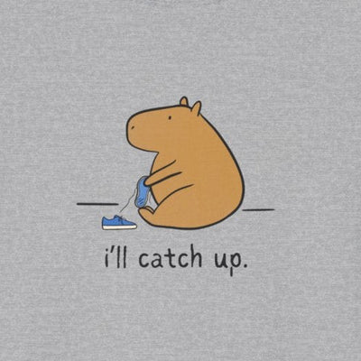Capy Life softstyle grey t-shirt featuring a hand-drawn capybara sitting with a sneaker and text i'll catch up.