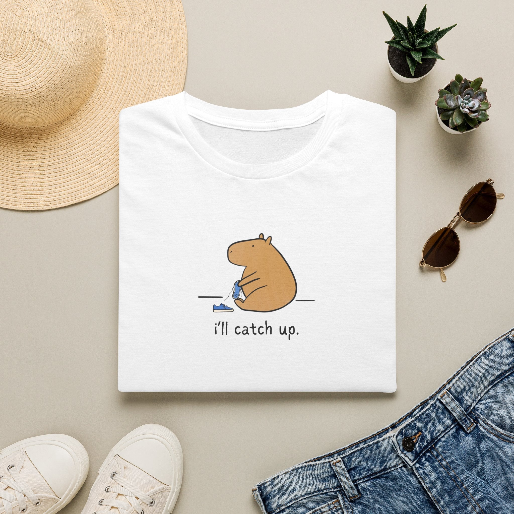 Capy Life white softstyle t-shirt featuring a minimalist illustration of a capybara sitting with the text i'll catch up