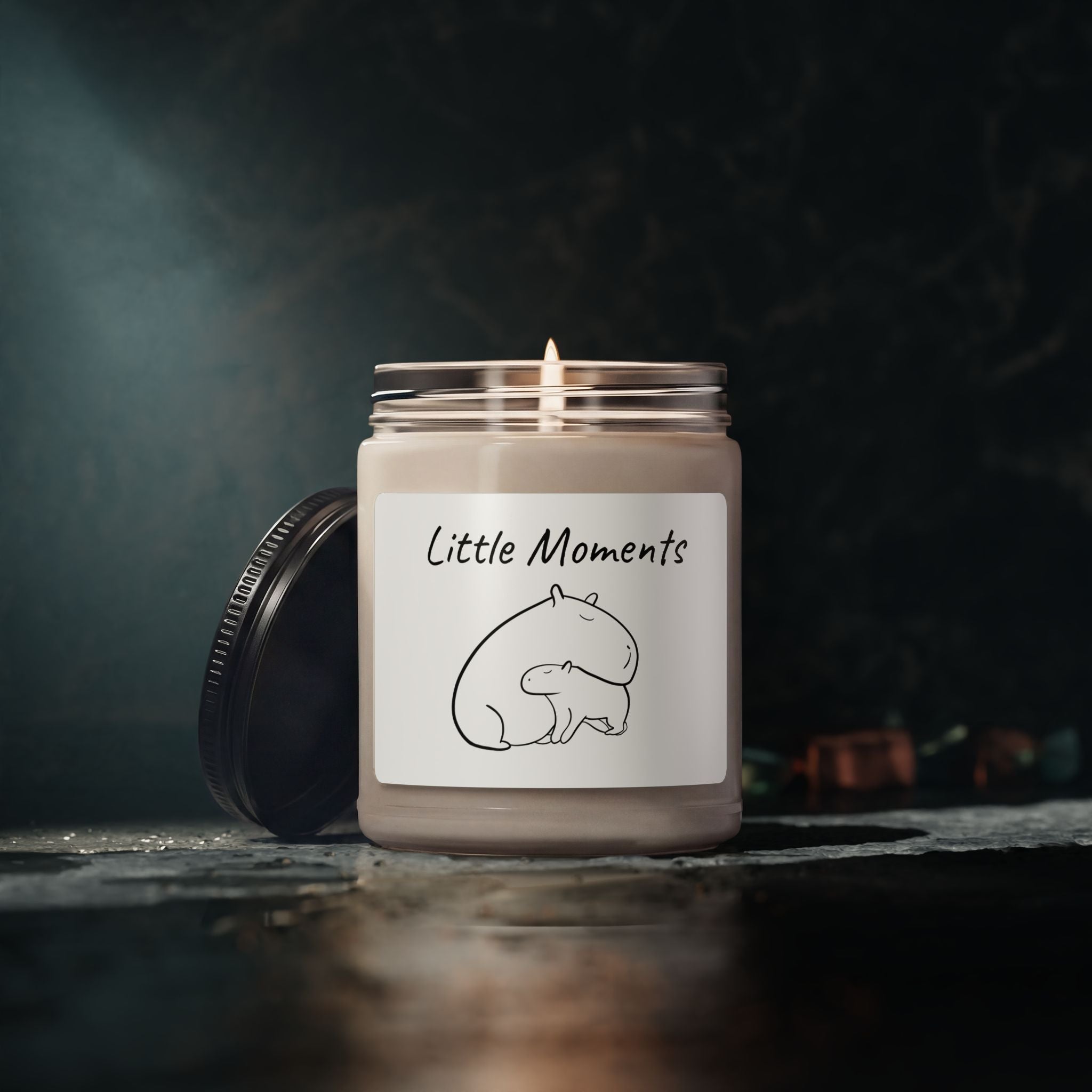 Capy Life soy wax candle in a glass jar with a minimalist capybara illustration label and a lit cotton wick