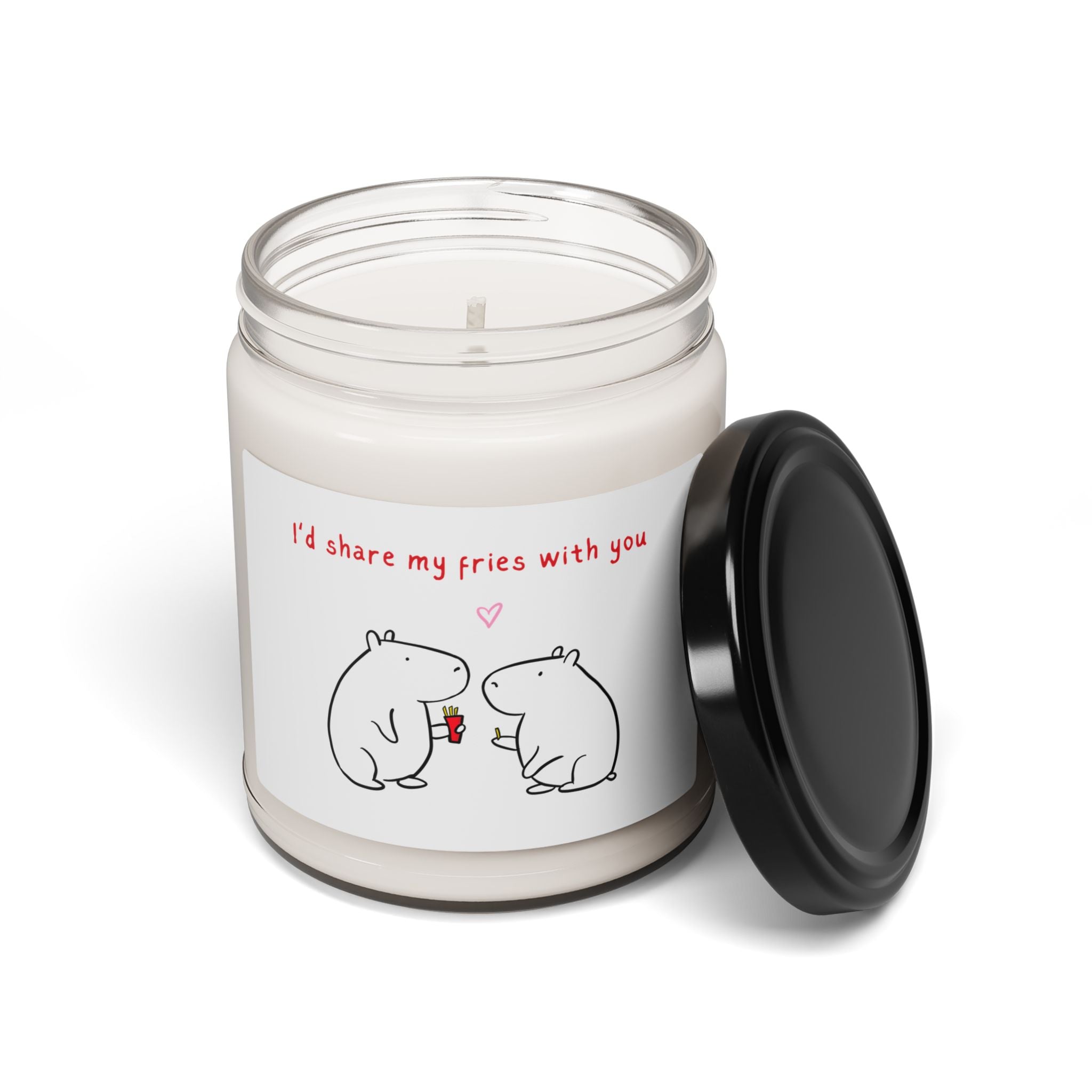 Capy Life soy candle in a glass jar with a label featuring two cute capybaras sharing fries and a romantic message.