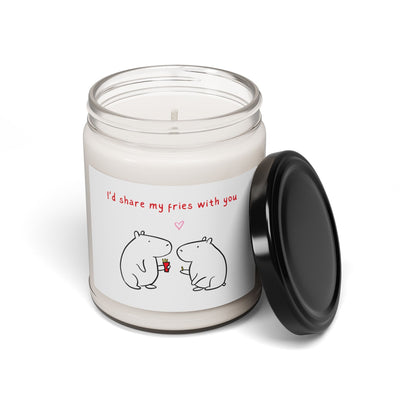 Capy Life soy candle in a glass jar with a label featuring two cute capybaras sharing fries and a romantic message.