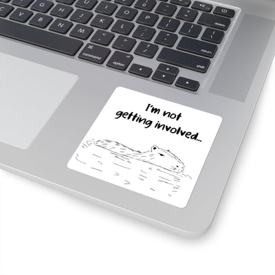 Capy Life vinyl sticker featuring a hand-drawn capybara floating in water with the text I’m not getting involved on a laptop