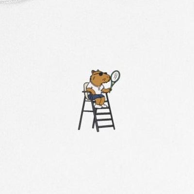 Capy Life kids performance tennis shirt featuring a small graphic of a capybara umpire holding a racquet