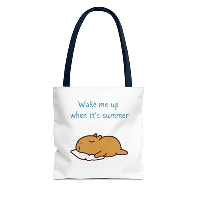 Capy Life white canvas tote bag featuring a cute illustration of a sleepy capybara and the text Wake me up when it's summer with dark blue handles.