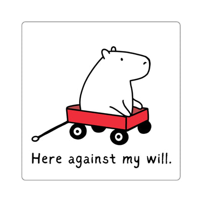 Capy Life vinyl sticker featuring a capybara in a red wagon with the text Here against my will in black and white.