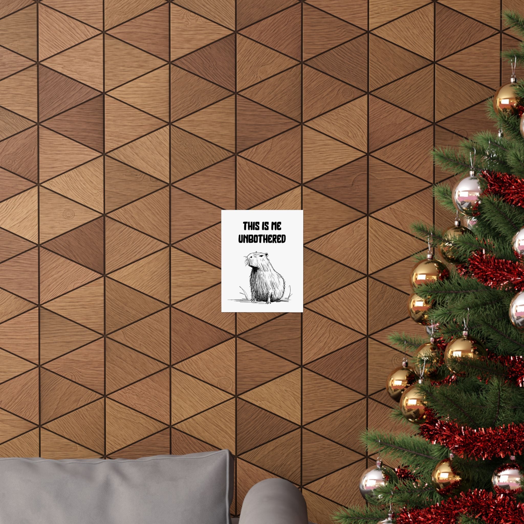 Capy Life minimalist capybara wall art print with the text This Is Me Unbothered hanging on a geometric wood wall.