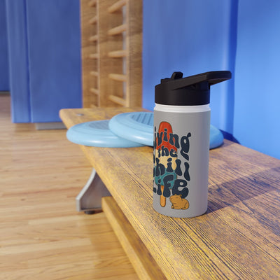 Capy Life insulated kids water bottle with retro popsicle design and capybara illustration on a wooden gym bench.