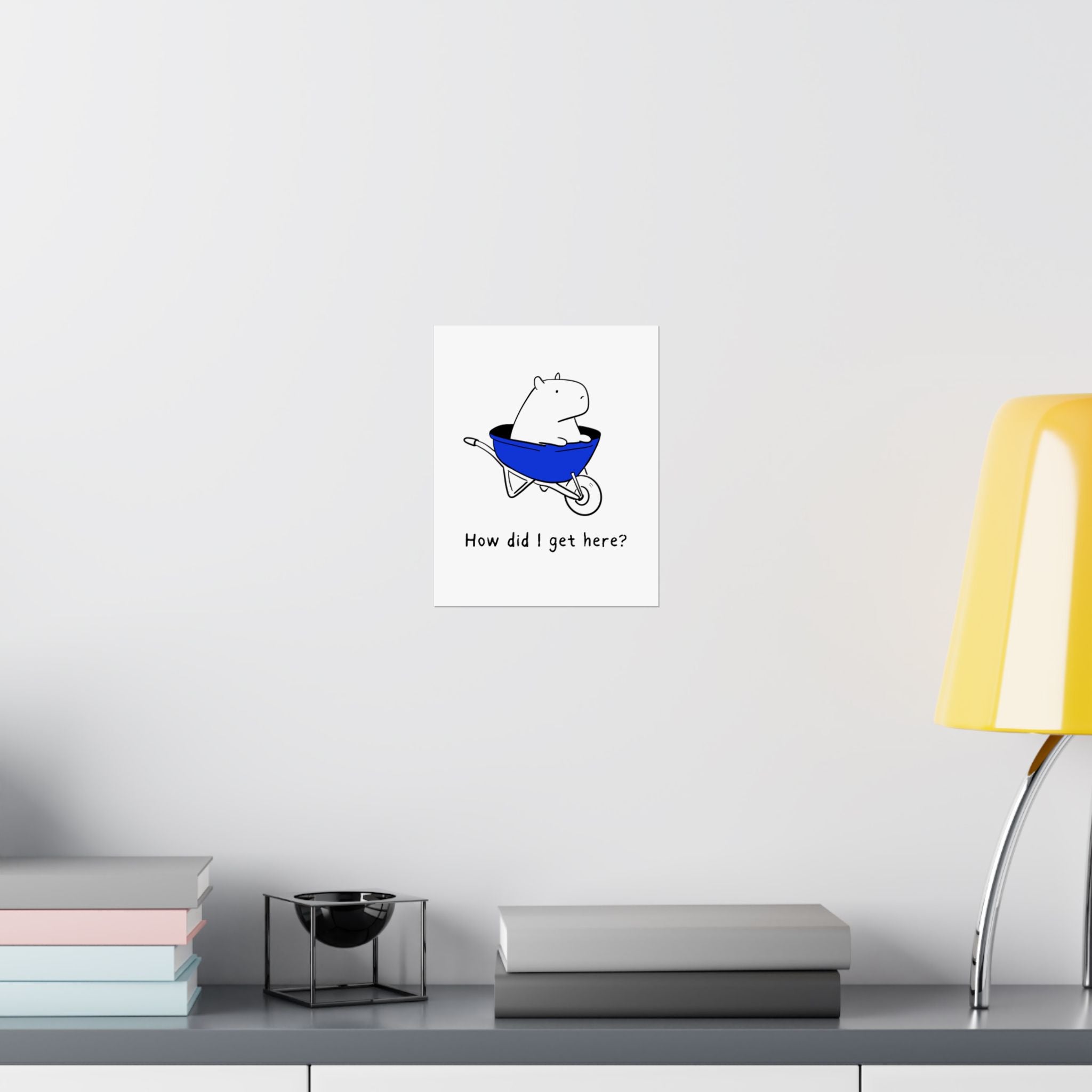 Capy Life minimalist wall art print featuring a capybara in a blue wheelbarrow with the text How did I get here?