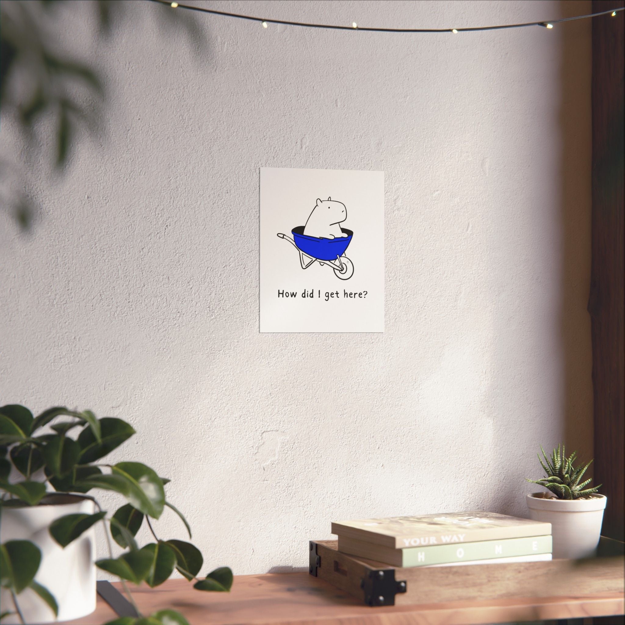 Capy Life minimalist wall art print featuring a capybara in a blue wheelbarrow with the text How did I get here?