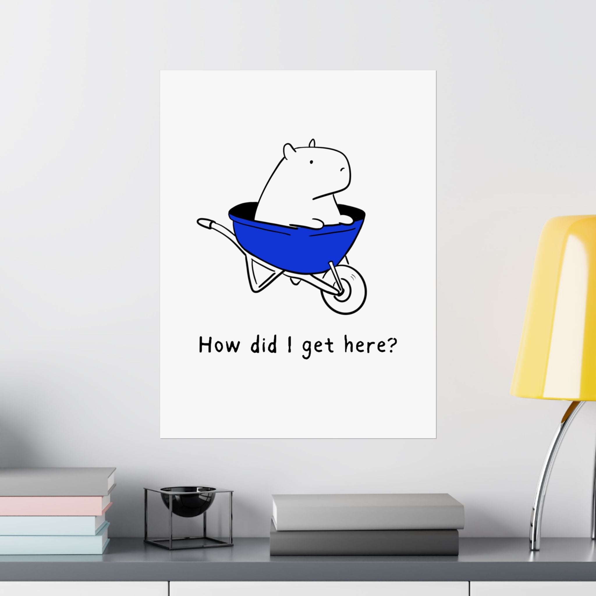 Capy Life minimalist wall art print featuring a capybara in a blue wheelbarrow with the text How did I get here?