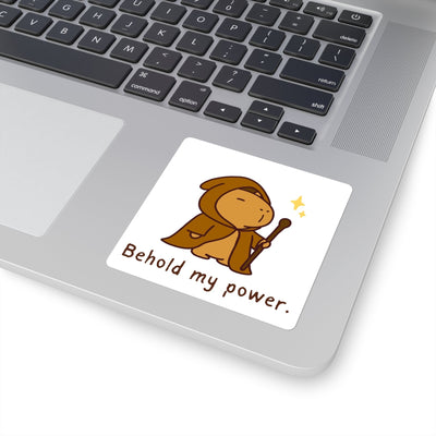 Capy Life sticker featuring a cute capybara wizard in a brown robe holding a staff on a silver laptop.