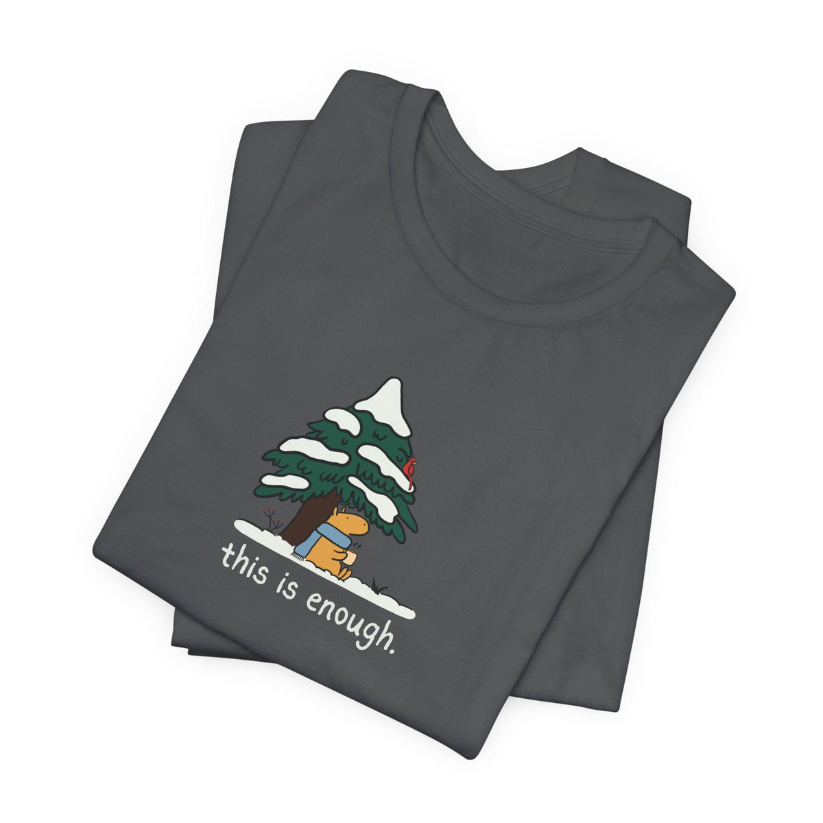 Capy Life charcoal grey t-shirt featuring a cute capybara in a blue scarf under a snowy evergreen tree graphic