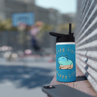 Capy Life 12oz stainless steel water bottle with a blue coastal capybara design and flip-top lid on a wooden ledge.