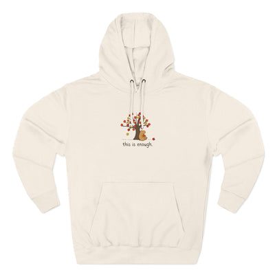 Capy Life beige fleece hoodie featuring a hand-drawn capybara under an autumn tree with the text this is enough.