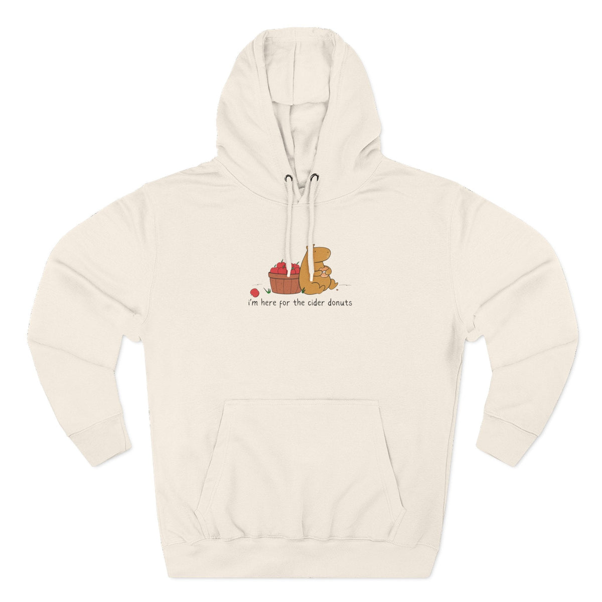 Capy Life cream fleece hoodie featuring a hand-drawn capybara eating a cider donut next to a basket of red apples.
