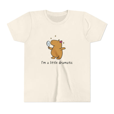Capy Life youth t-shirt in cream featuring a cute capybara with a pink bow looking into a mirror with sparkles.