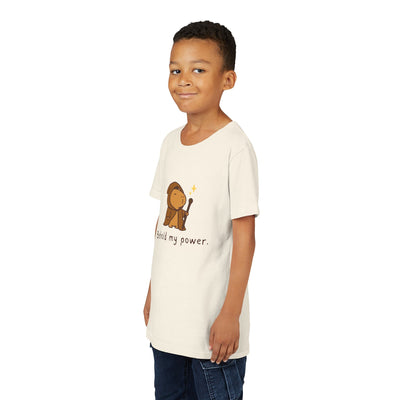 Capy Life kids t-shirt in cream featuring a cute wizard capybara graphic with the text Behold my power on a young boy