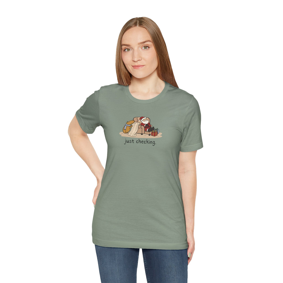 Capy Life softstyle t-shirt in sage green featuring a hand-drawn capybara checking Santa's naughty or nice list.