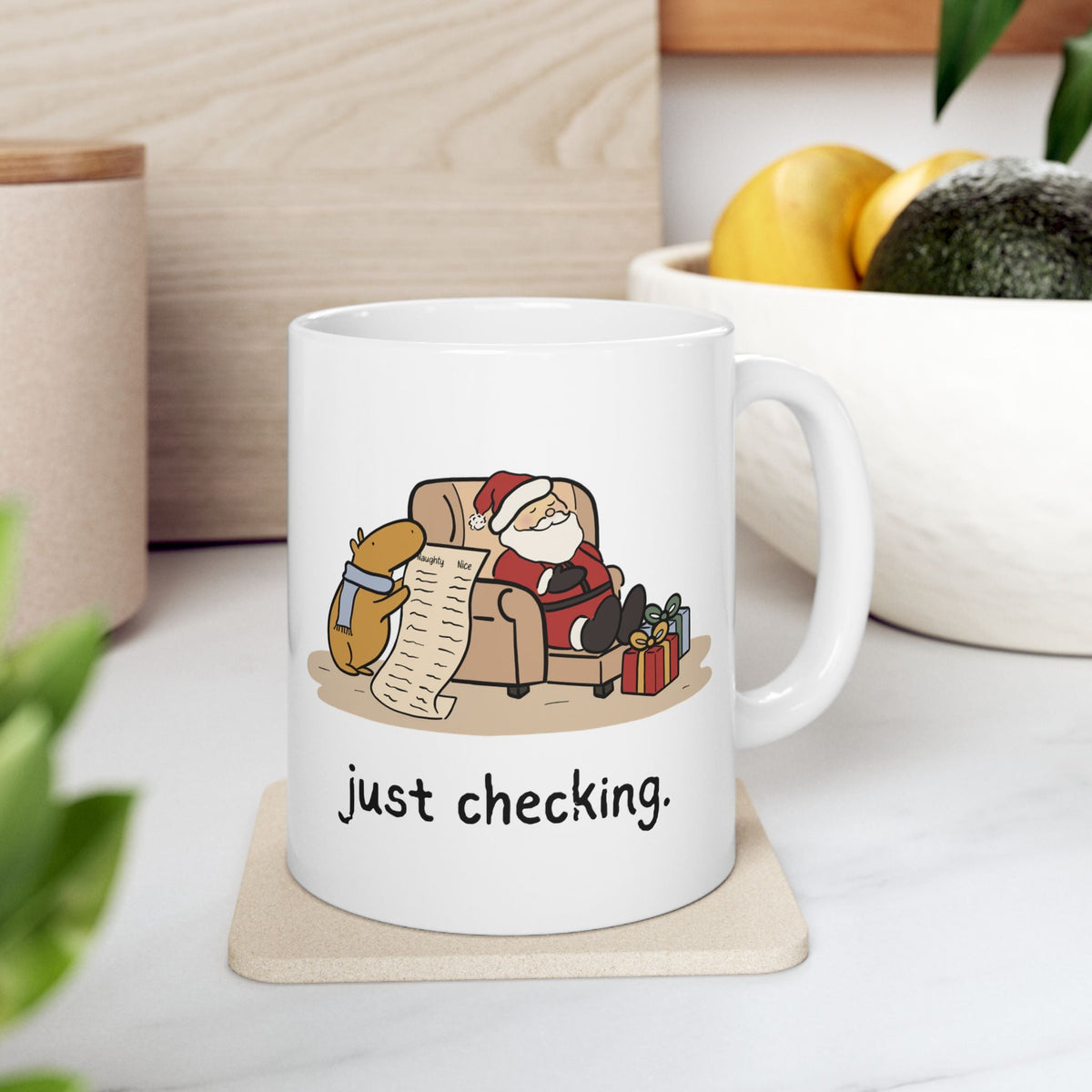 Capy Life white ceramic mug with a funny Christmas illustration of a capybara checking Santa's naughty or nice list.