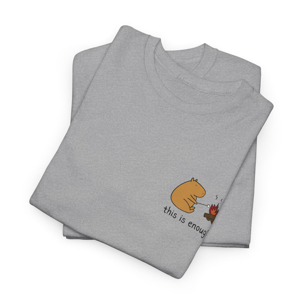 Capy Life grey heavyweight t-shirt featuring a small left-chest graphic of a capybara roasting a marshmallow by a fire.