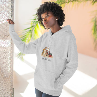 Capy Life grey fleece hoodie featuring a funny capybara illustration and the text just checking on a woman
