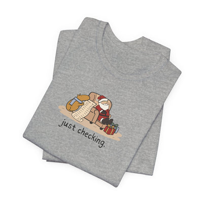 Capy Life grey softstyle t-shirt featuring a hand-drawn capybara checking Santa's naughty or nice list.