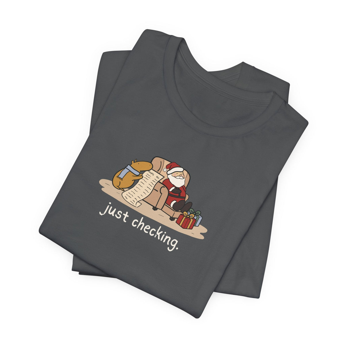 Capy Life dark grey t-shirt featuring a hand-drawn capybara checking Santa's naughty or nice list while he naps.