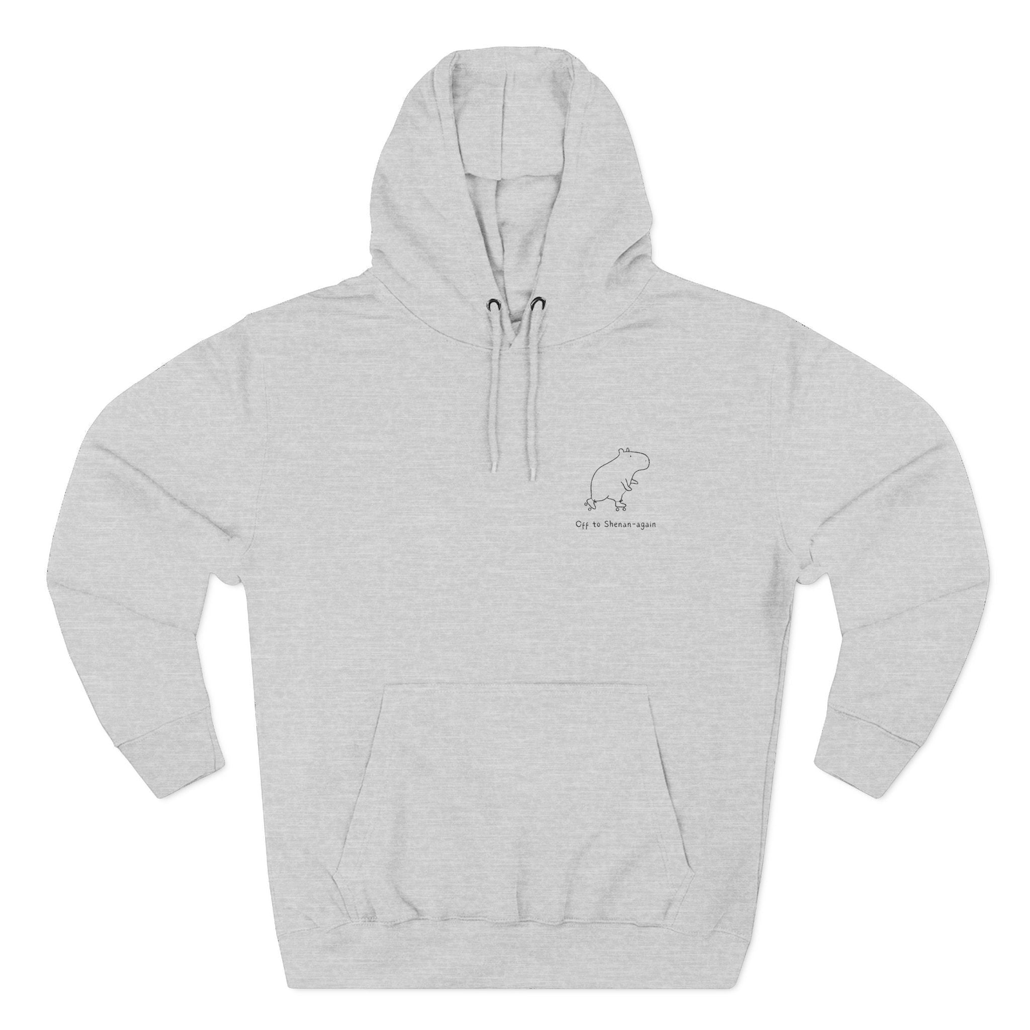 Capy Life grey unisex hoodie featuring a minimalist embroidered capybara graphic and Off to Shenan-again text.