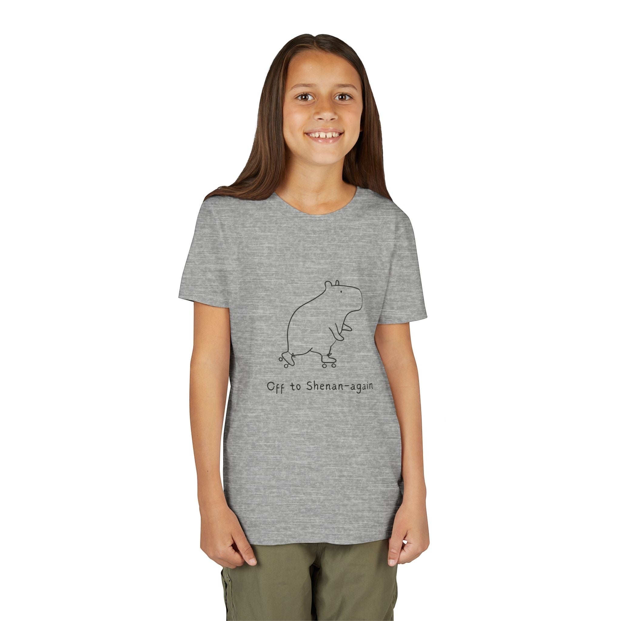 A young girl wearing a grey Capy Life graphic t-shirt featuring a doodle of a capybara on roller skates.