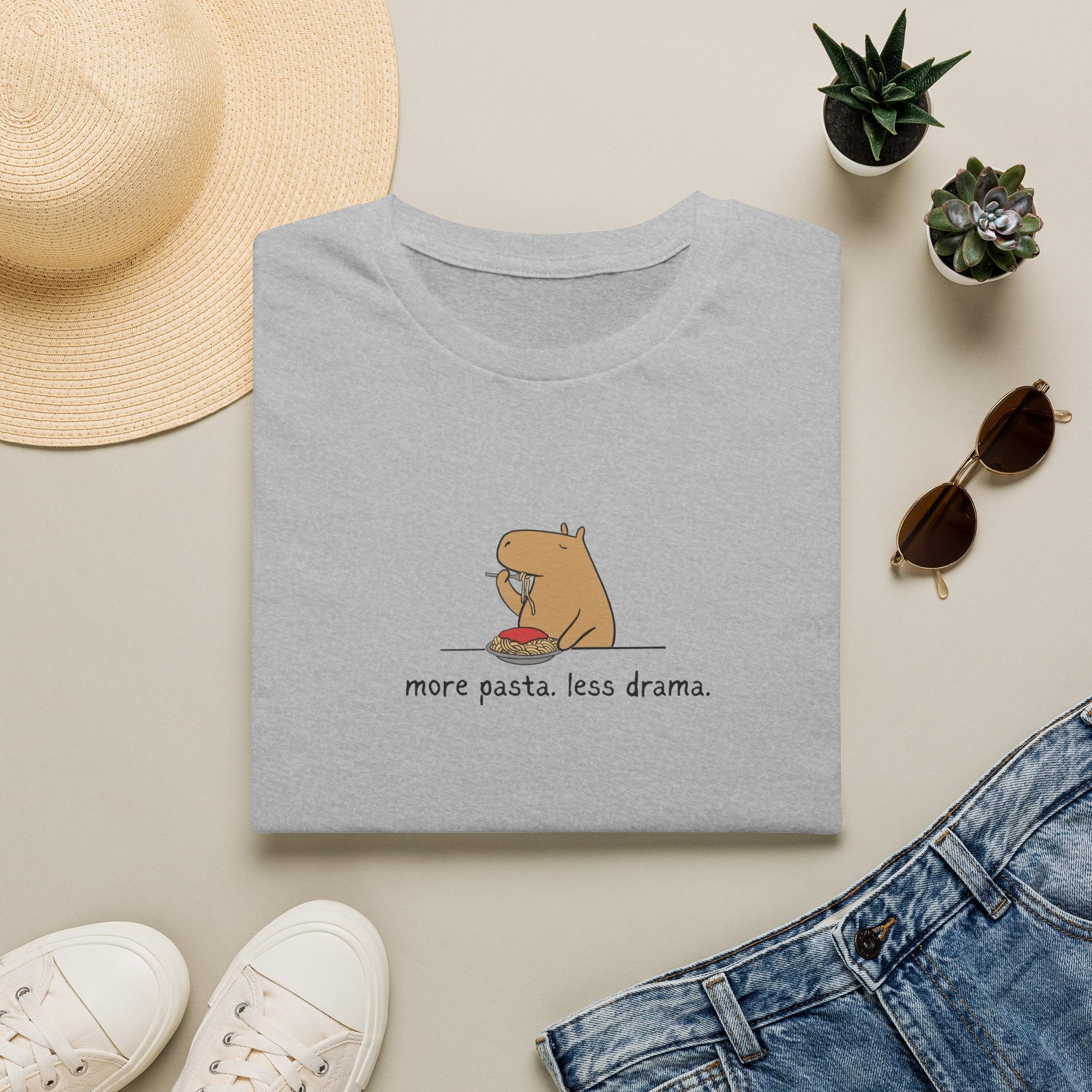 Capy Life grey softstyle t-shirt featuring a minimalist capybara eating spaghetti with the text more pasta less drama