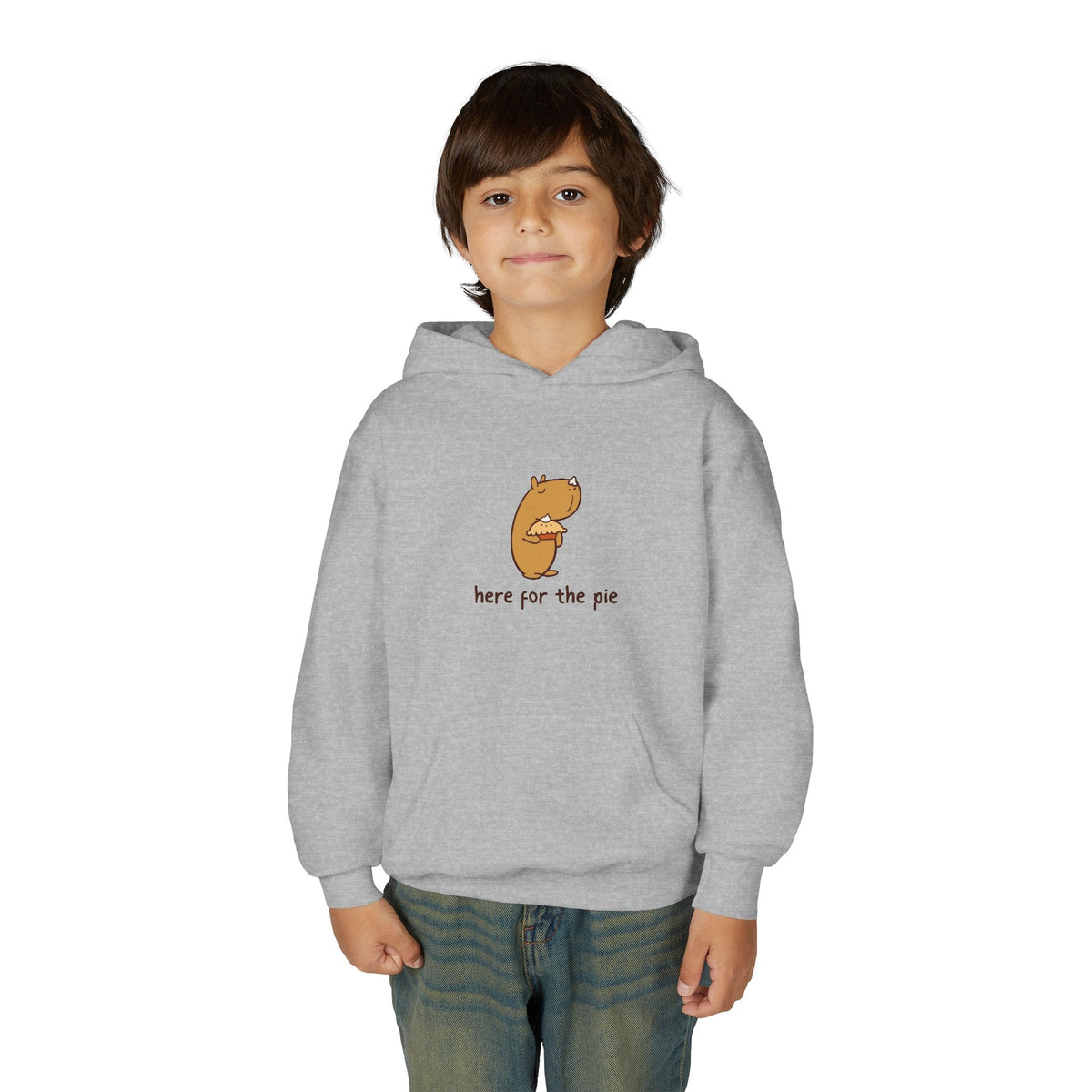 Child wearing a grey Capy Life hoodie featuring a cute illustration of a capybara holding a slice of pie.