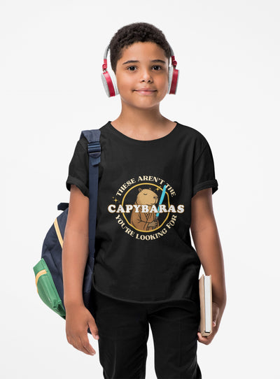 Capy Life youth wearing a black cotton t-shirt with a Jedi capybara comic badge graphic and blue lightsaber