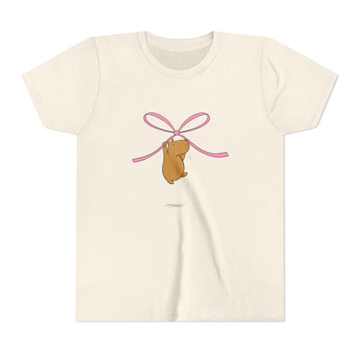 Capy Life kids cream t-shirt featuring a cute capybara graphic hanging from a pink coquette ribbon bow
