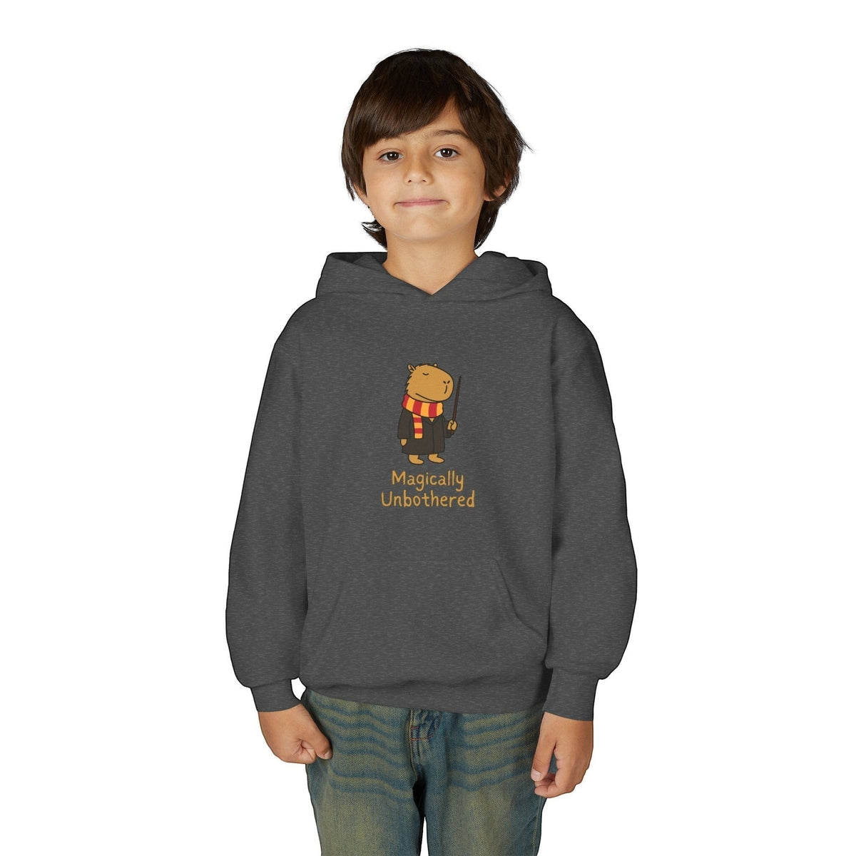 Capy Life kids dark grey hoodie featuring a cute capybara wizard illustration with the text Magically Unbothered.