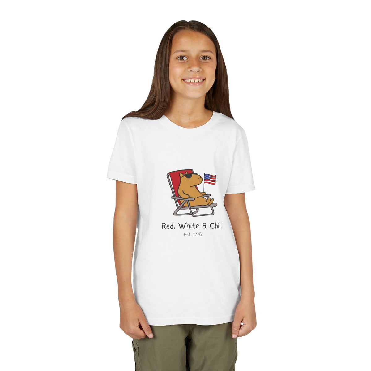 Capy Life youth white t-shirt featuring a capybara in sunglasses lounging in a chair with an American flag