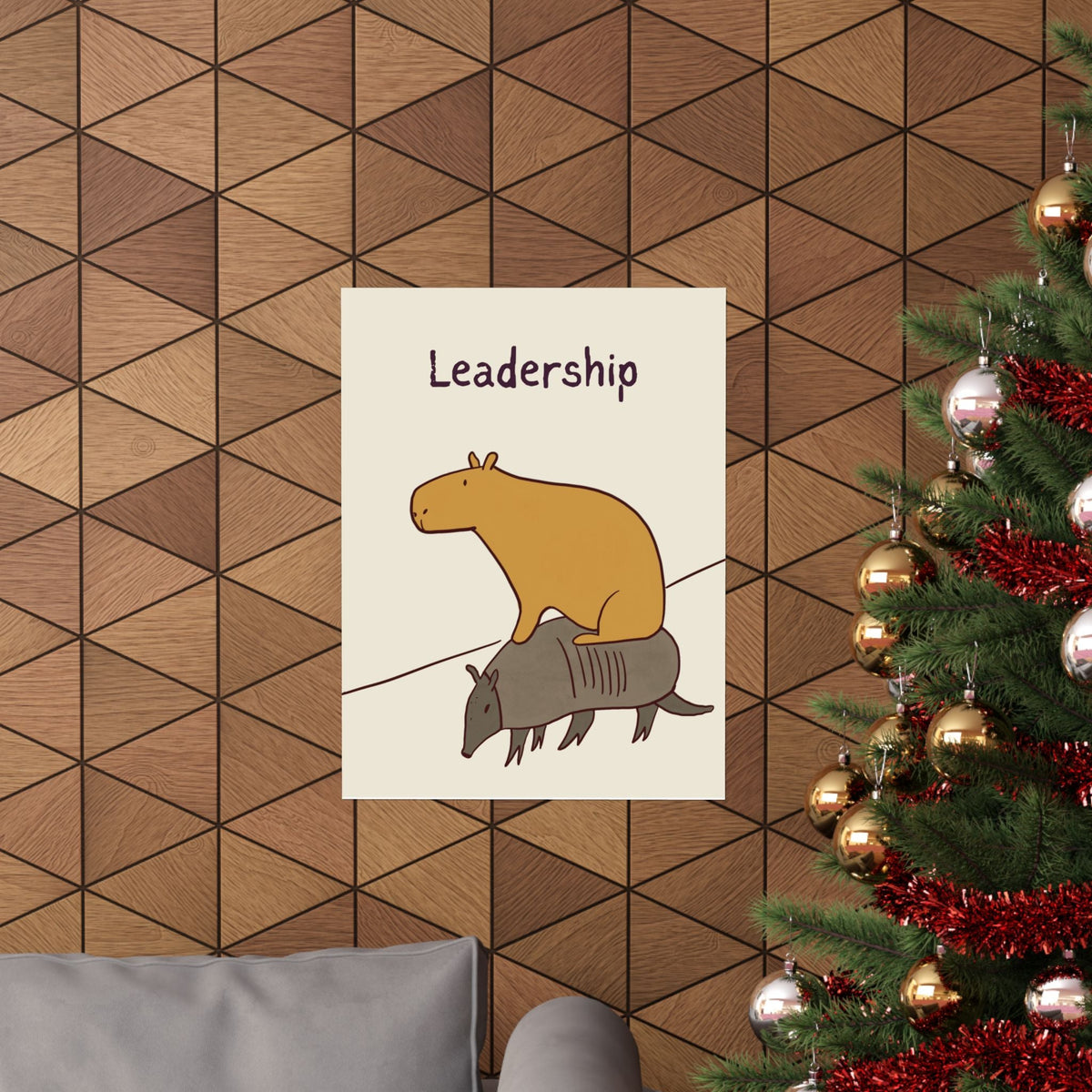 Capy Life minimalist wall art print featuring a capybara riding an armadillo under the text Leadership on a wood wall.