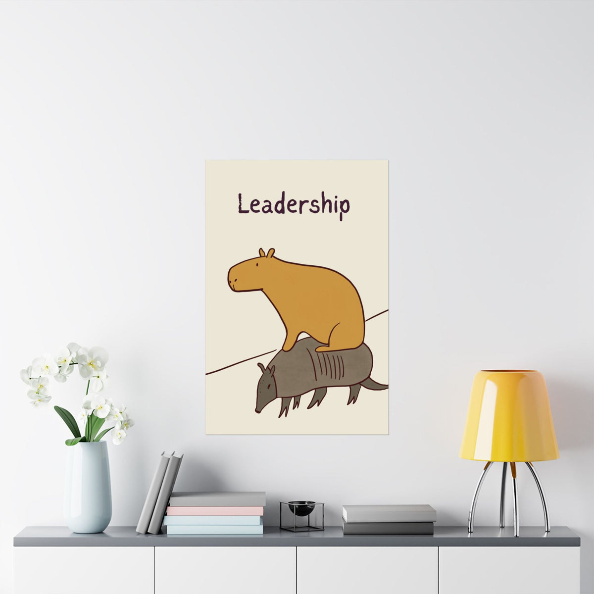 Capy Life minimalist wall art print featuring a capybara riding an armadillo with the word Leadership above.