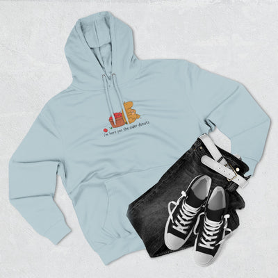 Capy Life light blue fleece hoodie featuring a hand-drawn capybara eating a donut with apples, styled with black jeans.
