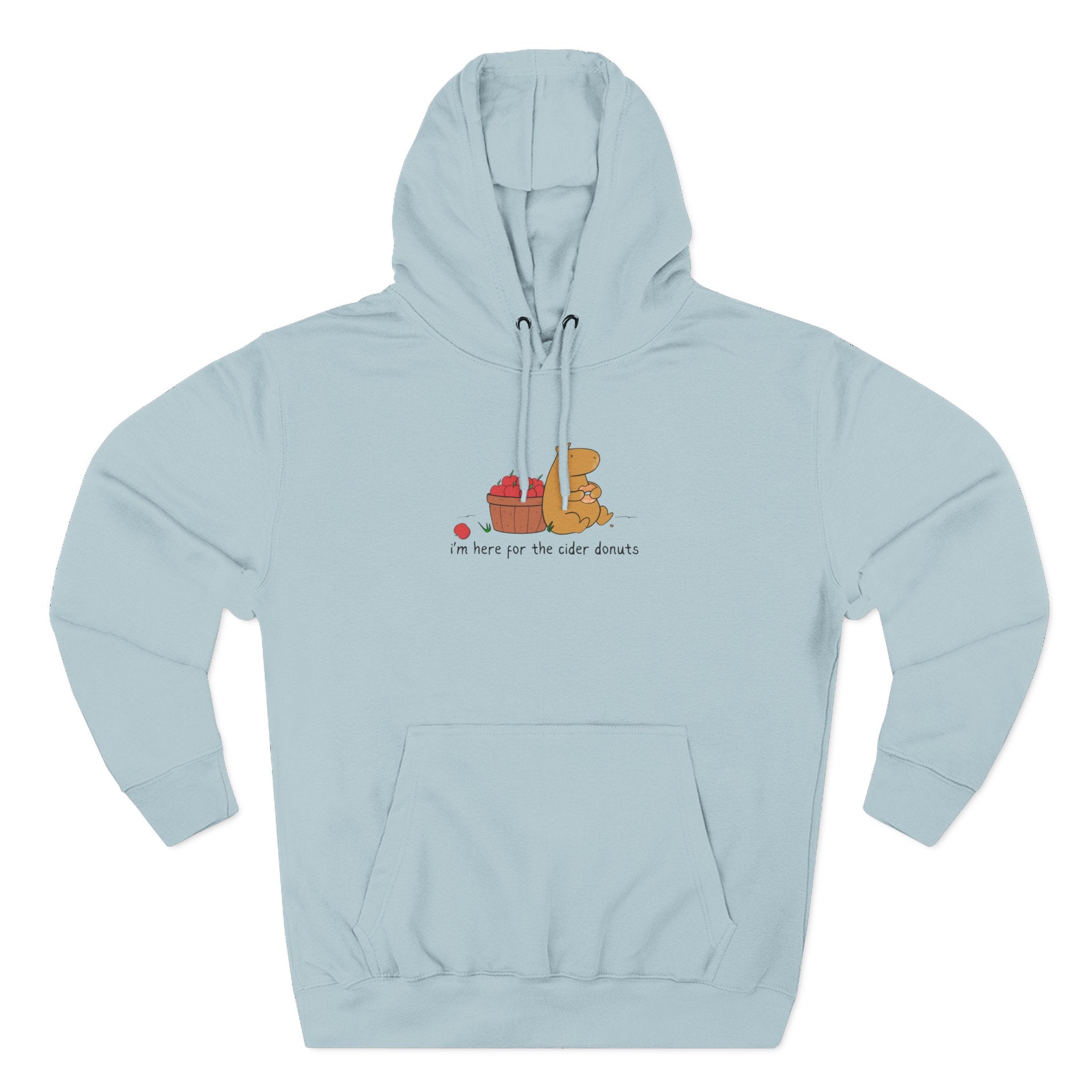 Capy Life light blue fleece hoodie featuring a hand-drawn capybara eating a cider donut next to a basket of apples.