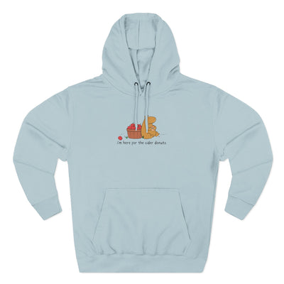 Capy Life light blue fleece hoodie featuring a hand-drawn capybara eating a cider donut next to a basket of apples.