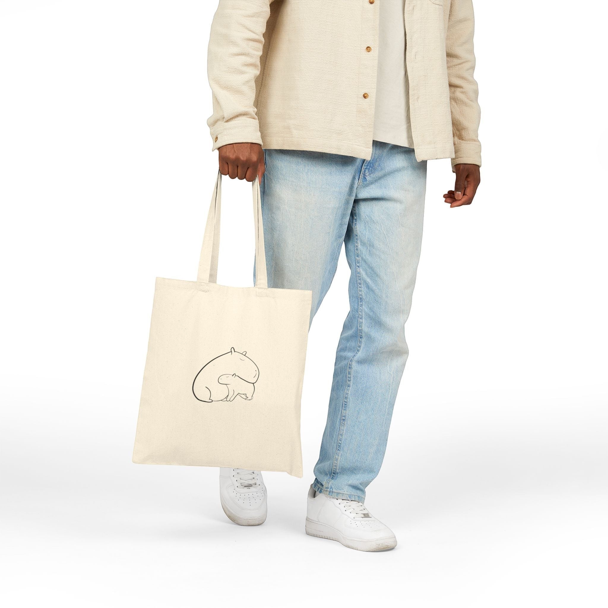 Capy Life natural canvas tote bag featuring a minimalist line drawing of a mother and baby capybara snuggling.