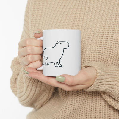 Capy Life white ceramic mug featuring a minimalist black line drawing of a mother and baby capybara