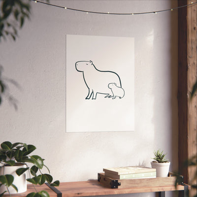 Capy Life minimalist line drawing of a mama and baby capybara on a white wall above a wooden shelf with plants