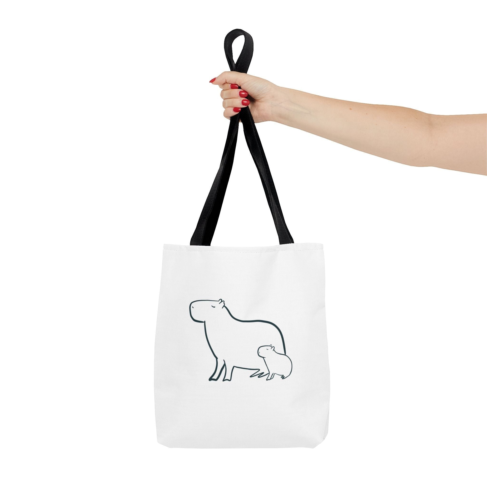 Capy Life minimalist white tote bag featuring a black line art illustration of a mother and baby capybara.