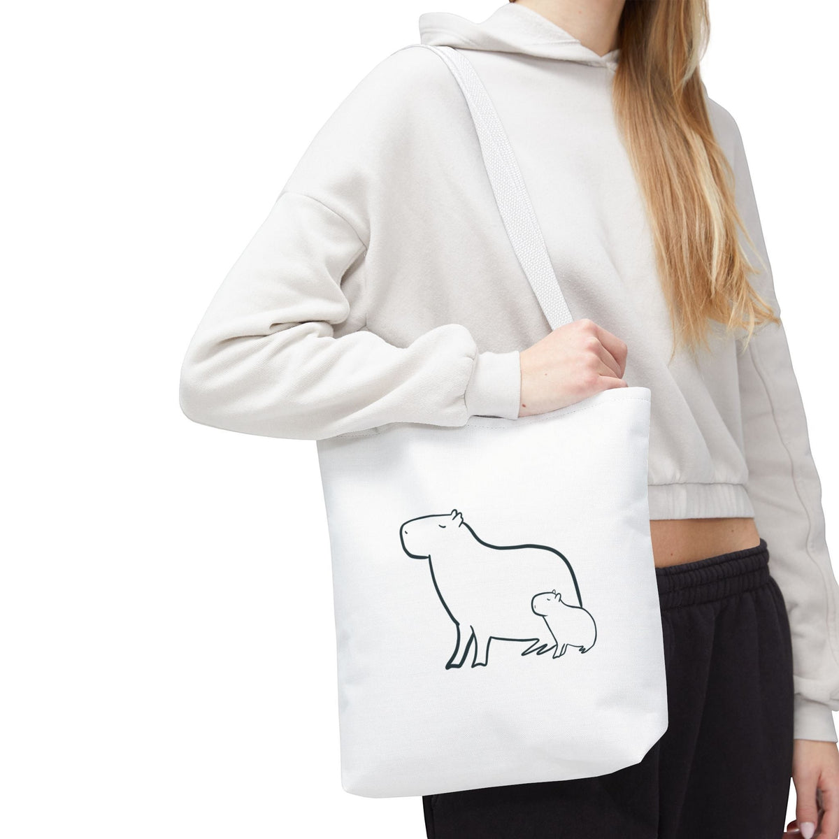 Capy Life white minimalist tote bag featuring a black line art illustration of a mother and baby capybara.